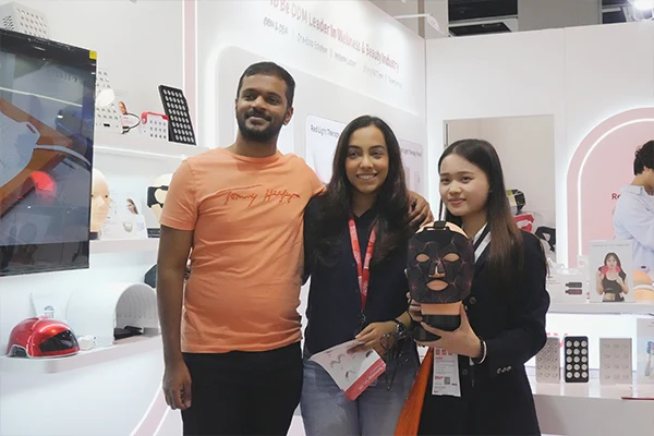 Wakelife sales representatives take photos with customers at a beauty show
