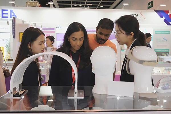 Wakelife sales representatives take photos with customers at a beauty show