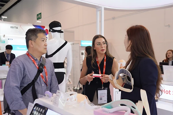 Wakelife sales representatives take photos with customers at a beauty show