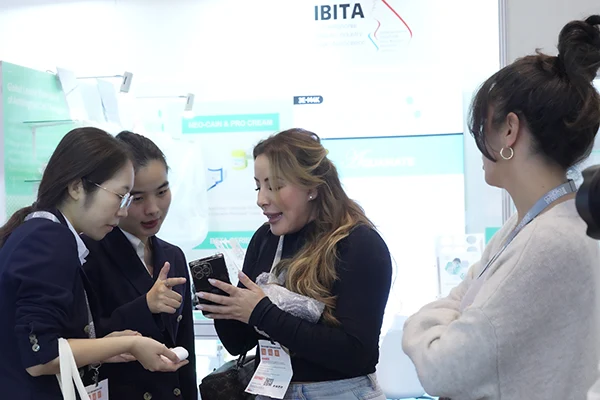 Wakelife sales representatives take photos with customers at a beauty show