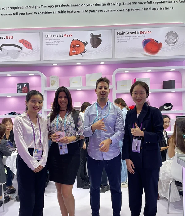 Wakelife sales representatives take photos with customers at a beauty show