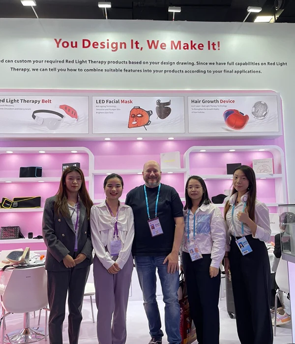 Wakelife sales representatives take photos with customers at a beauty show