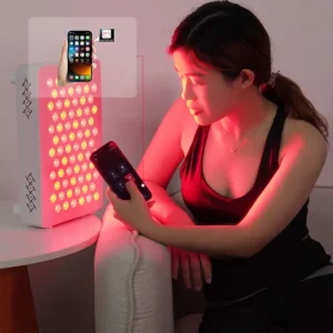 User controlling the ESPLUS360 red light therapy panel with a mobile app during a home treatment session