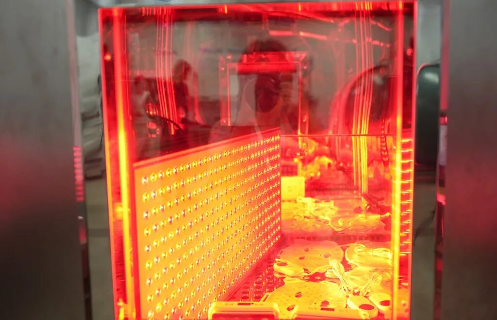 Close-up of red light therapy panels and LED masks undergoing temperature and humidity environmental testing at WAKELIFE.