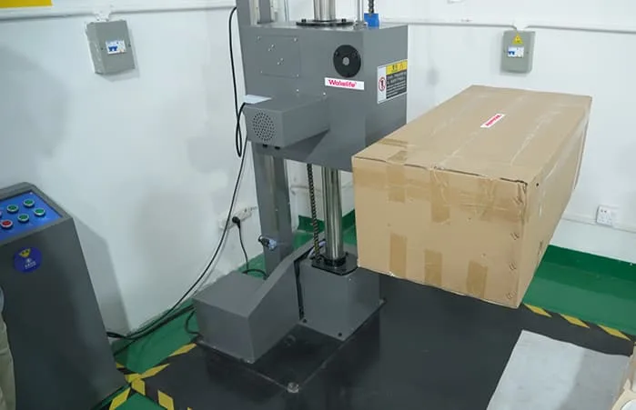 WAKELIFE packaging drop test machine used to test carton durability for red light therapy device shipments.