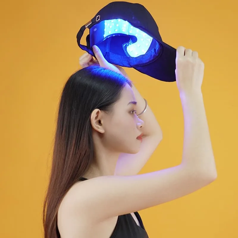 Woman wearing the C02 hair growth cap with blue LEDs