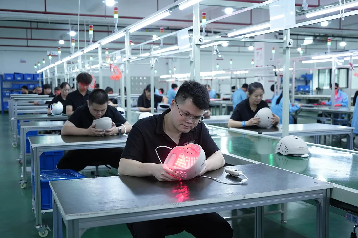 Operator testing controller functions: power, timer, brightness for hair growth cap