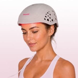 Model wearing the HC03 silicone VCSEL laser hair growth cap with red light active