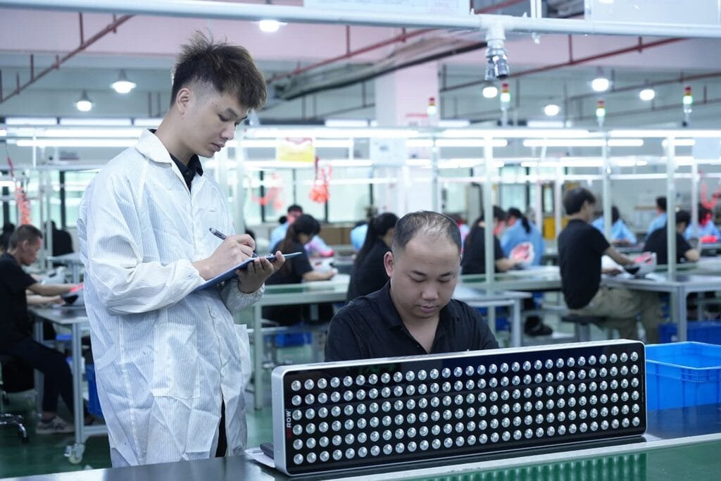 Quality inspector checking red light therapy panel production details