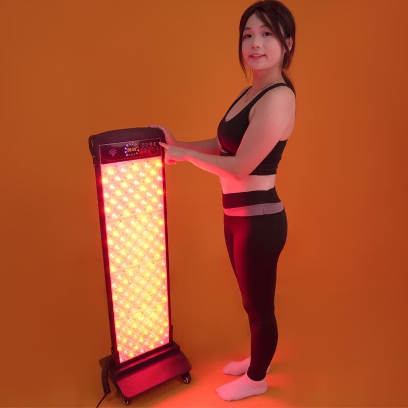 Woman positioning the Wakelife SL280 sauna red light panel on a wheeled floor stand